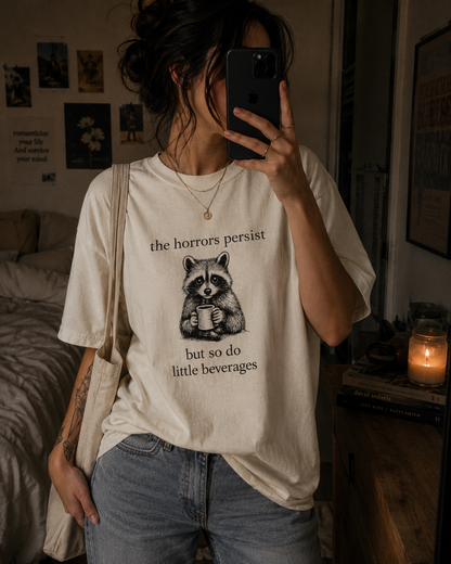 The Horrors Persist But So Do Little Beverages Shirt ☕🦝